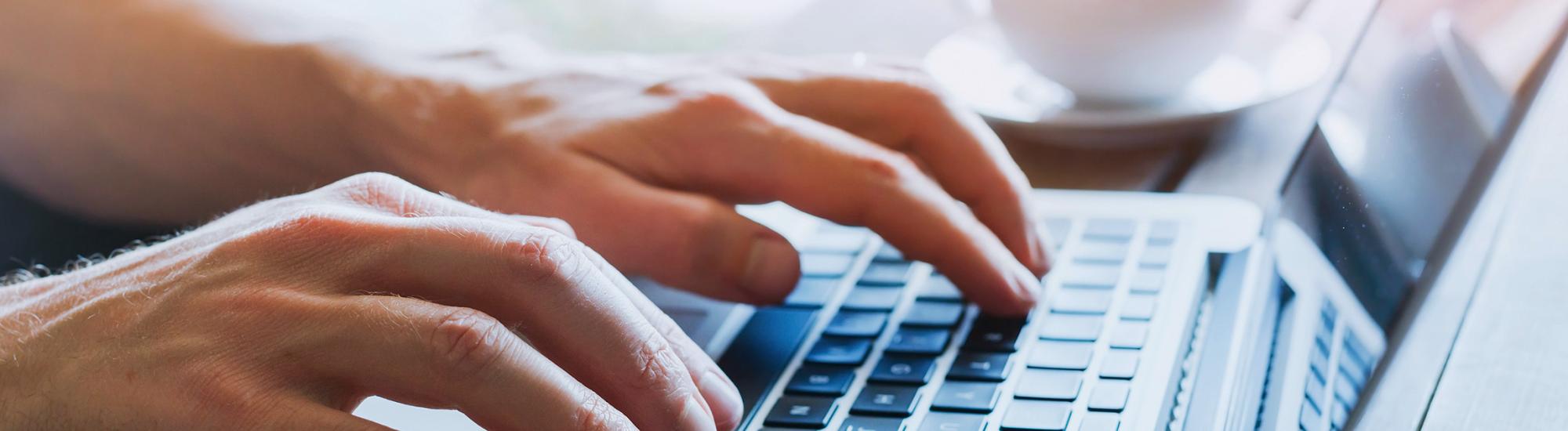 person typing on a laptop